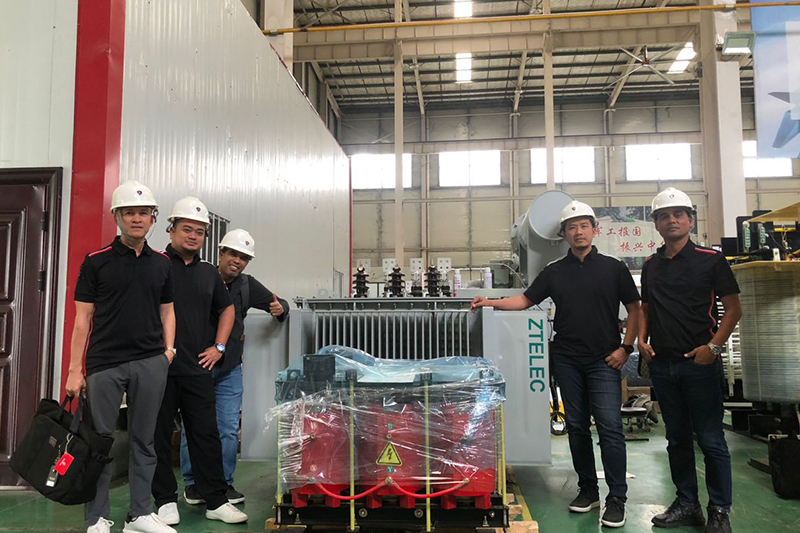 Group photo with transformer in factory