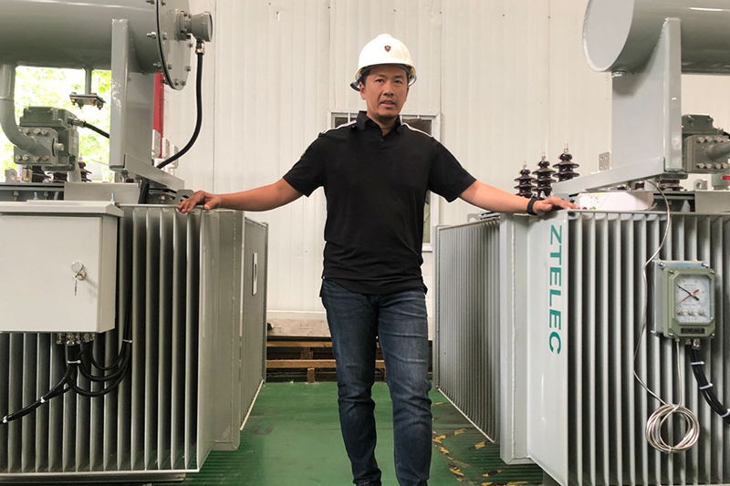 Engineer inspecting oil-immersed transformers